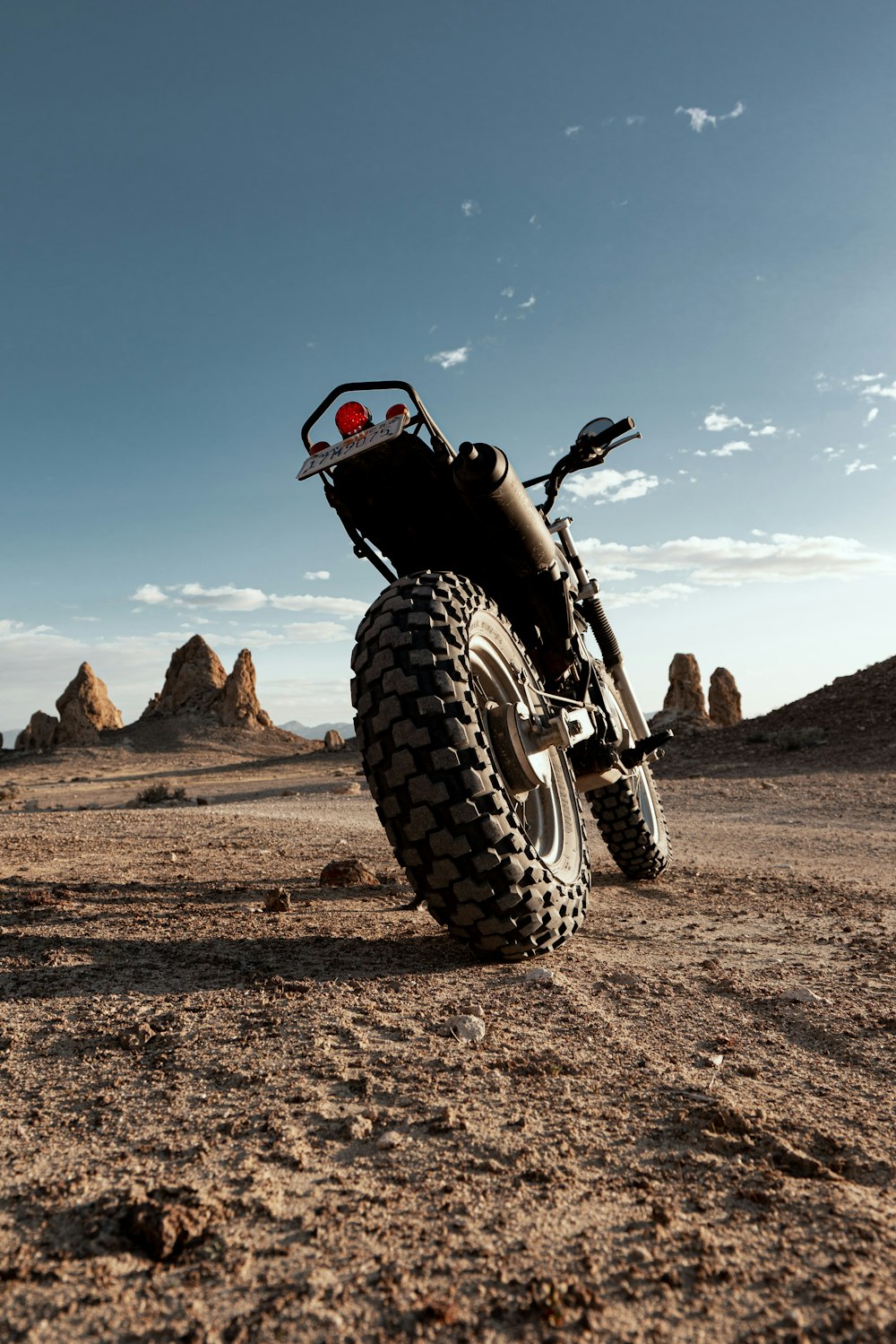 black and red atv on brown field during daytime