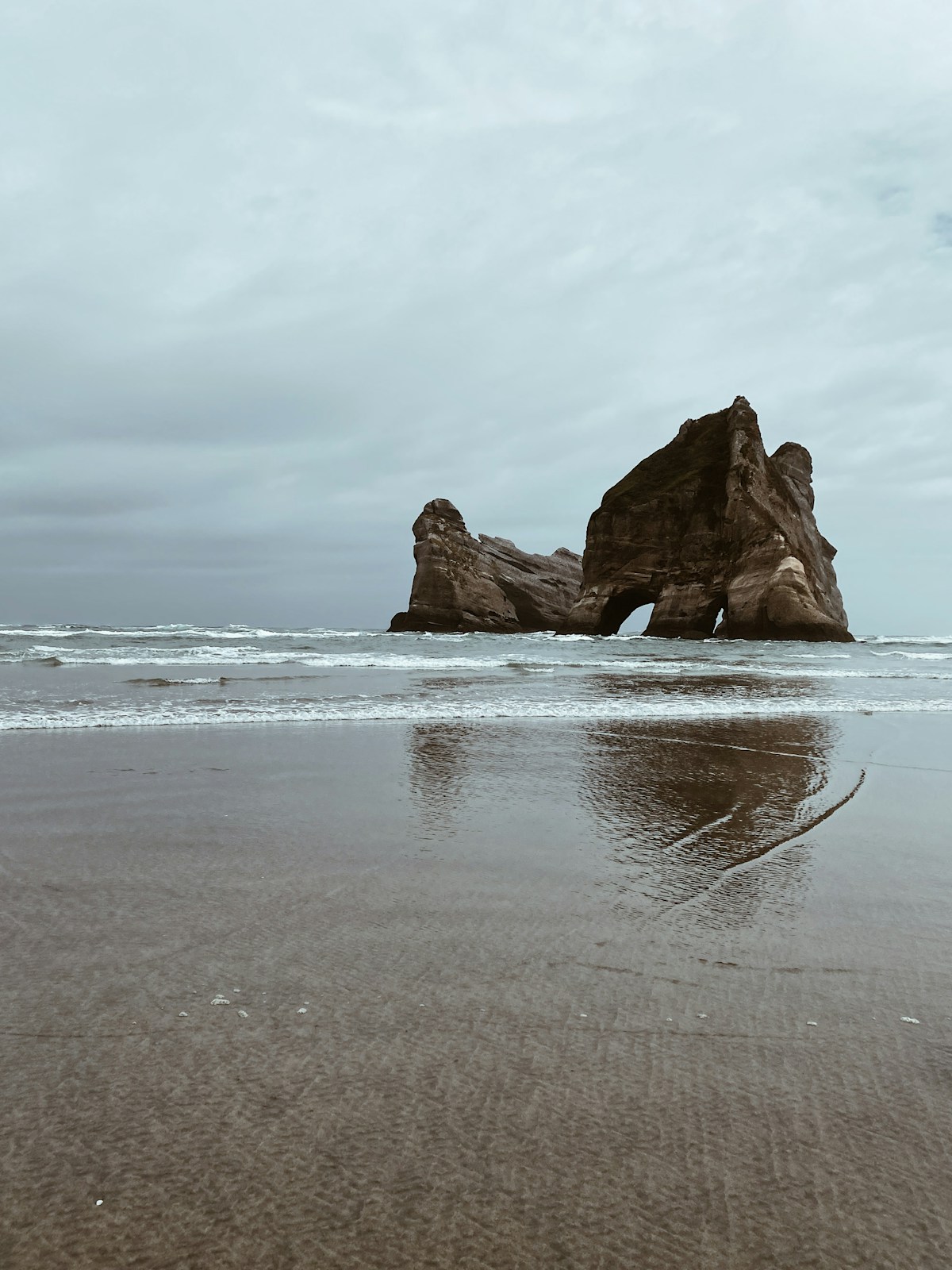 Wharariki Beach rock arches and sand dunes, Golden Bay New Zealand