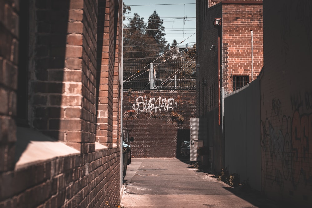brown brick wall with graffiti