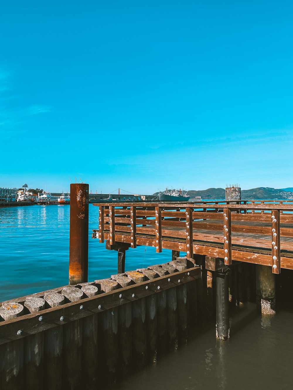 brown wooden dock on blue sea under blue sky during daytime