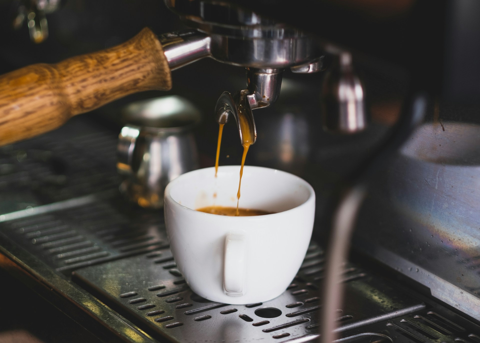 white ceramic cup on silver espresso machine