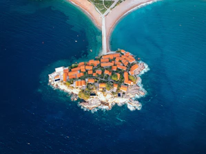 aerial view of city buildings near body of water during daytime