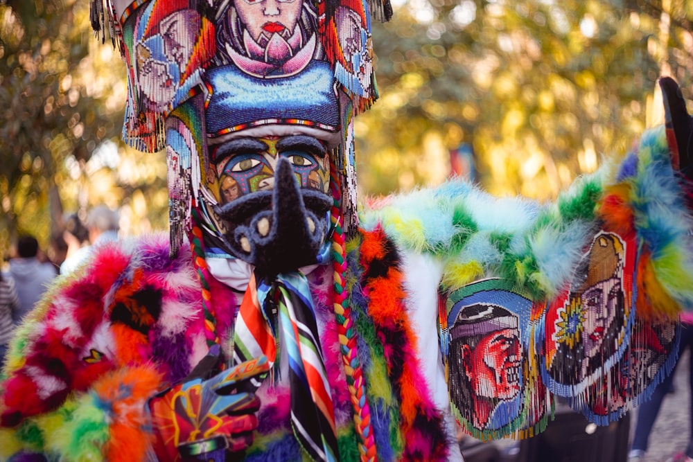 person wearing yellow green and purple floral mask