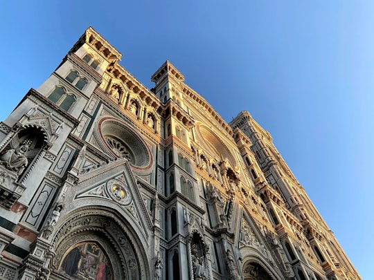 brown concrete building under blue sky during daytime in Cathedral of Santa Maria del Fiore Italy
