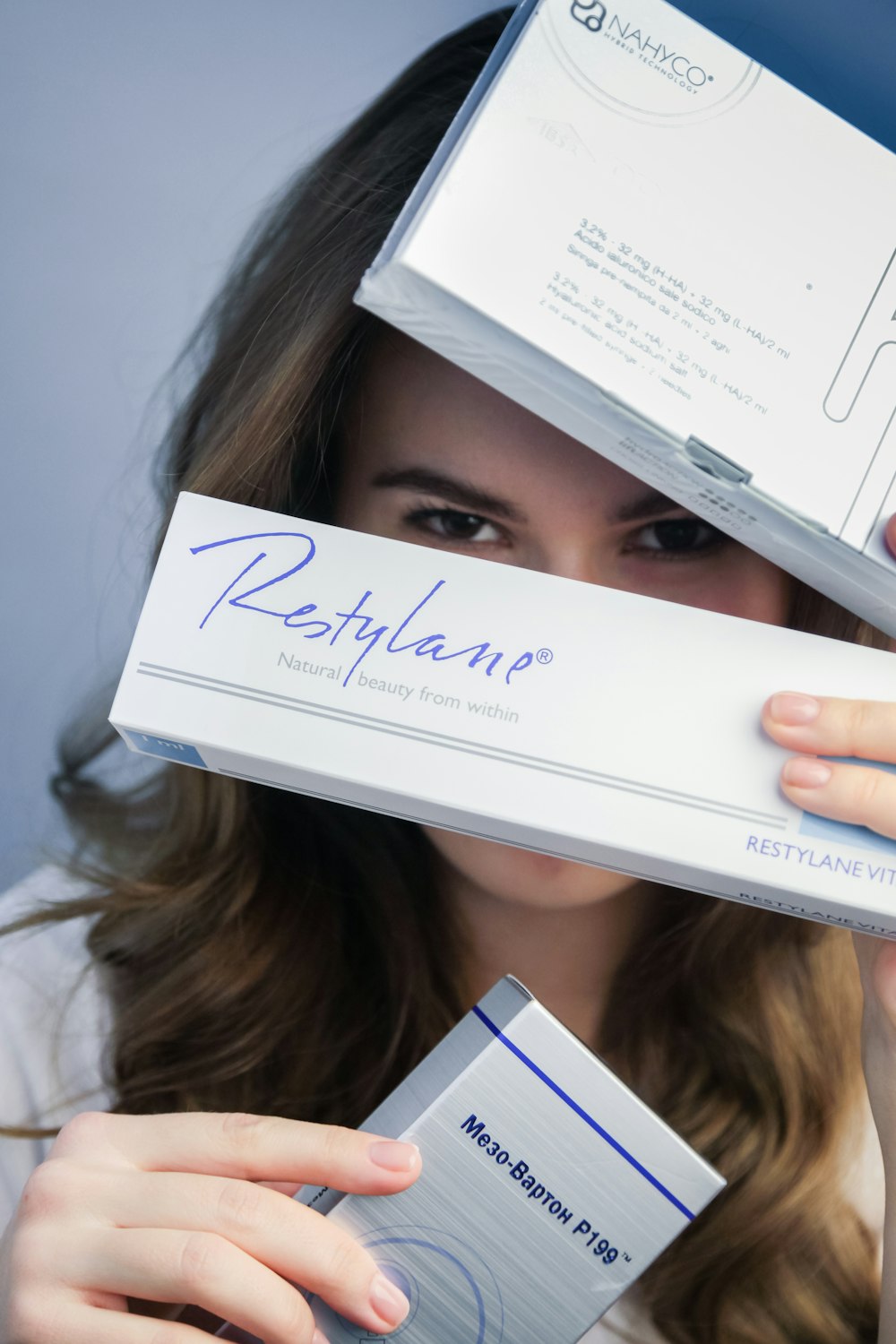 woman holding white and blue box