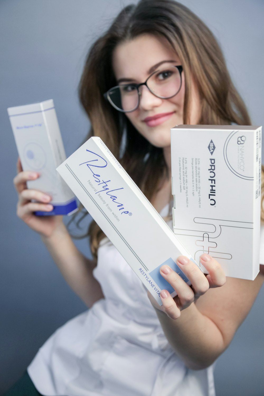 woman in white shirt holding white box