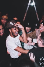 man in white crew neck t-shirt wearing black cap