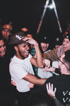man in white crew neck t-shirt wearing black cap