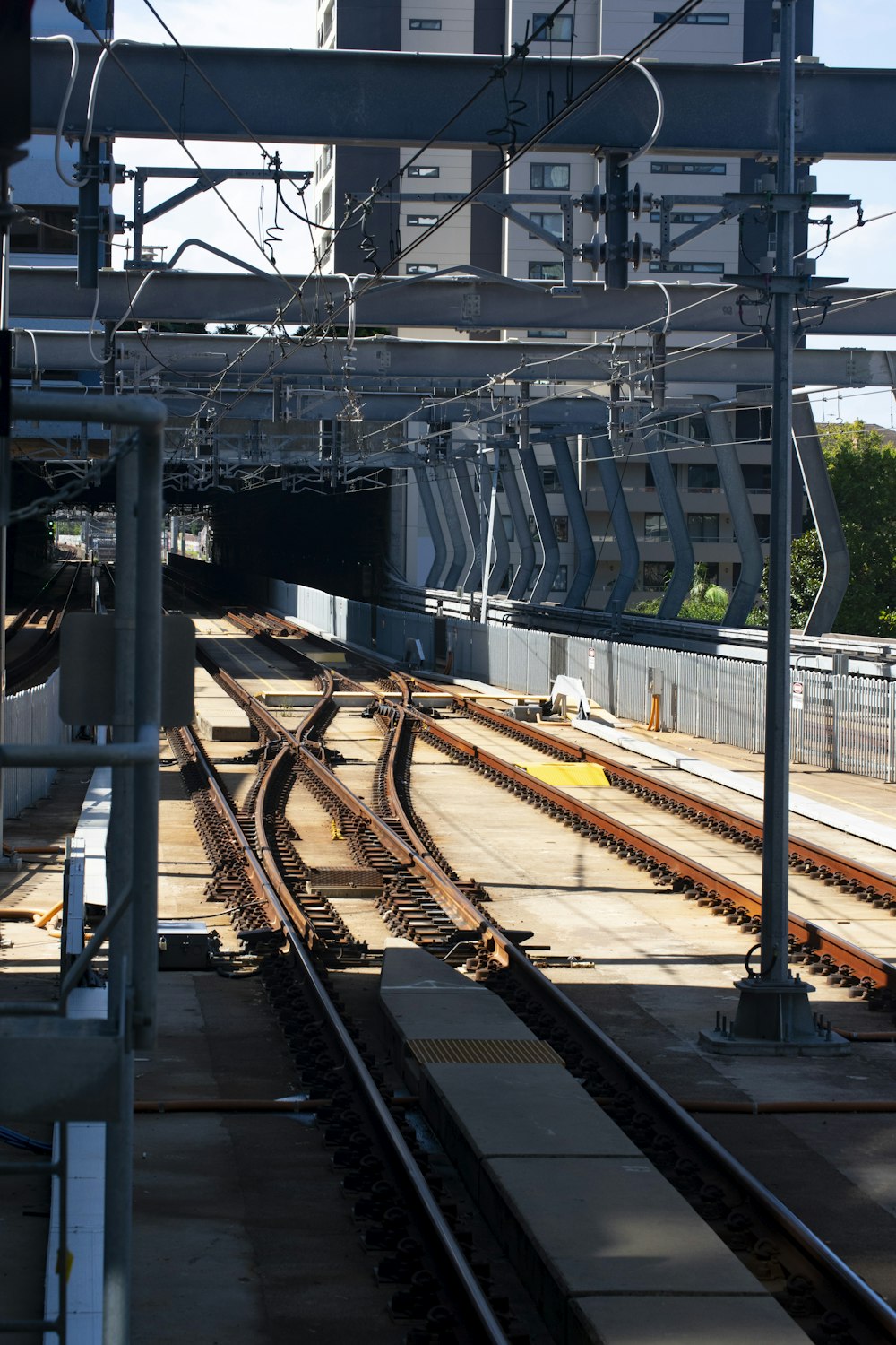 gray metal train rail during daytime
