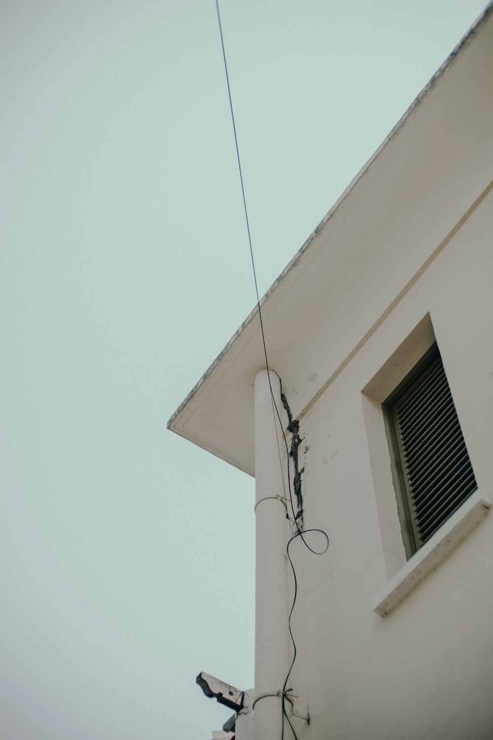 white window type air conditioner on white wall