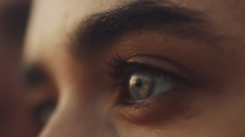 persons blue eyes in close up