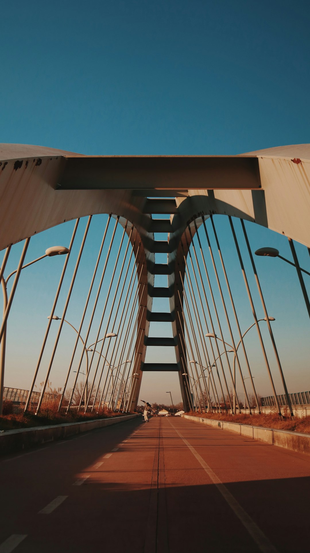 brown metal bridge under blue sky during daytime