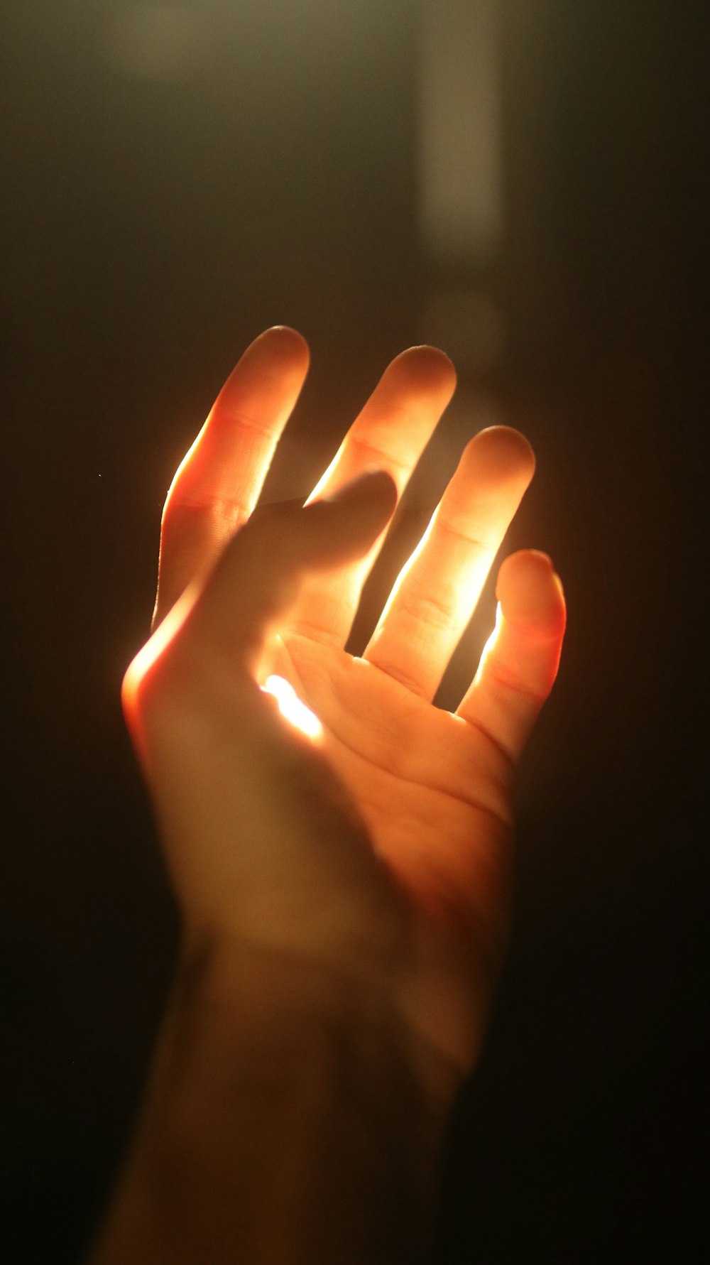 persons hand on black background