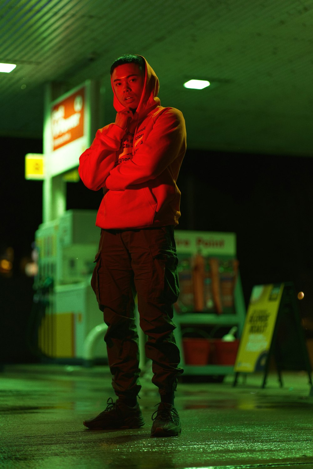 a man in a red jacket standing in a parking lot