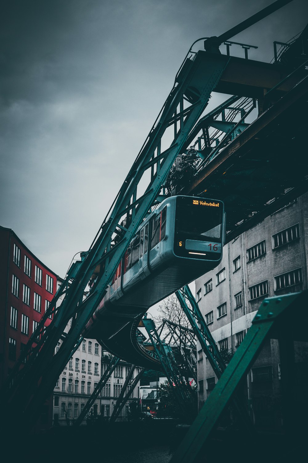 green and black train on rail tracks