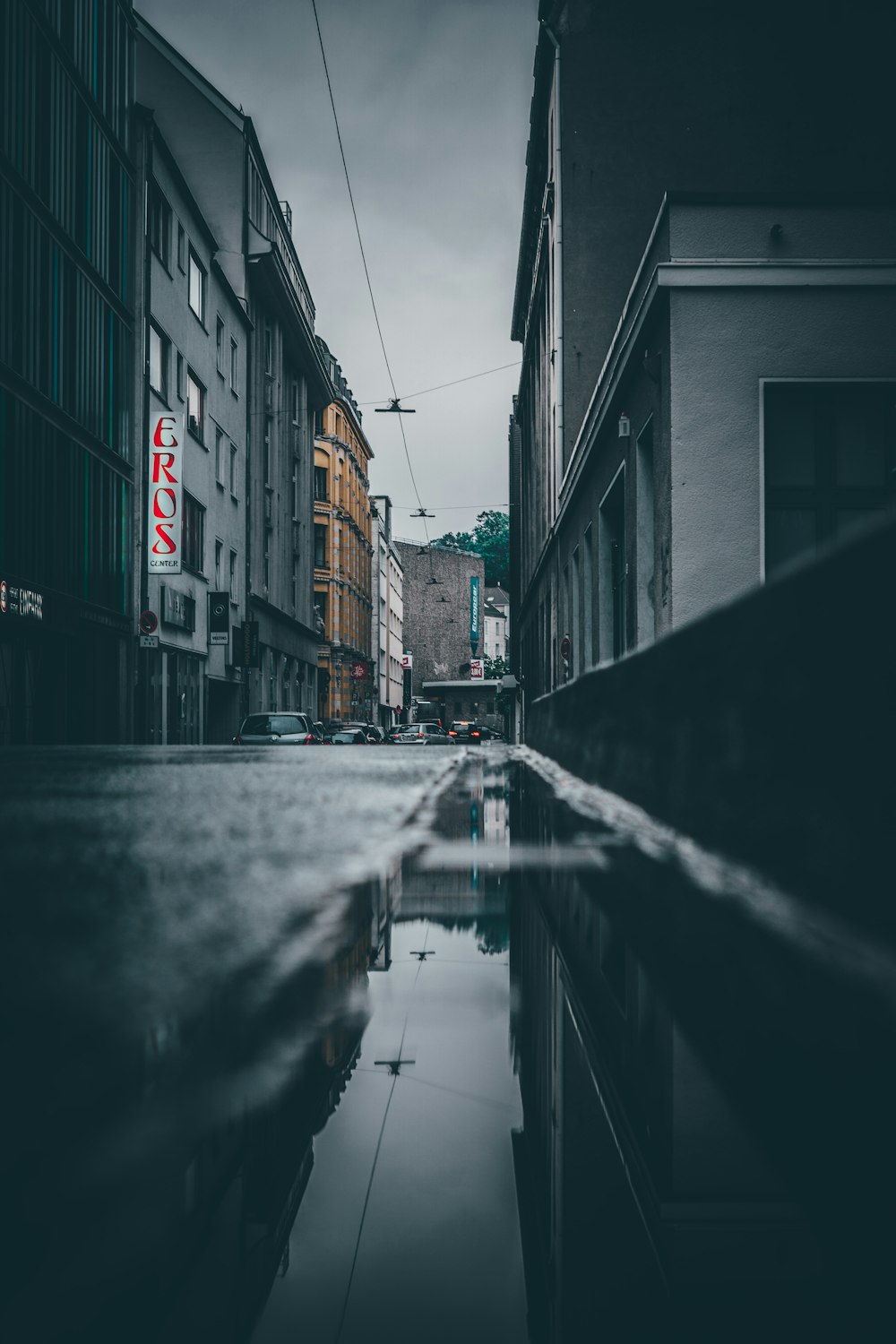 grayscale photo of empty street between buildings