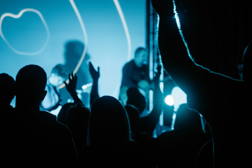 silhouette of people standing on stage