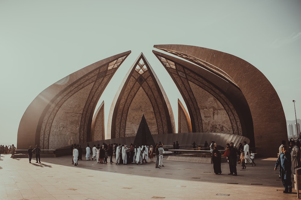 people walking on brown concrete building during daytime