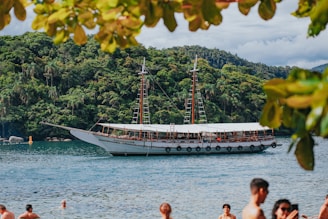 people on white and blue boat on sea during daytime