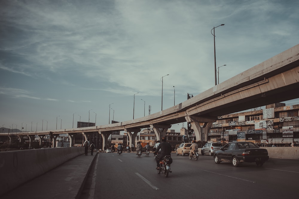 people riding motorcycle on road during daytime