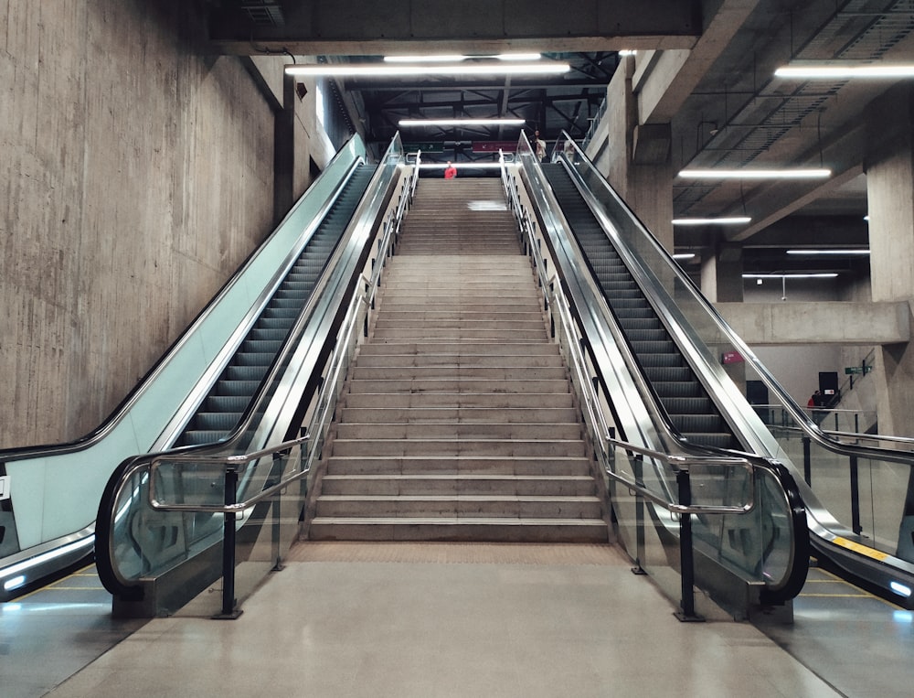 green and brown escalator in brown concrete building