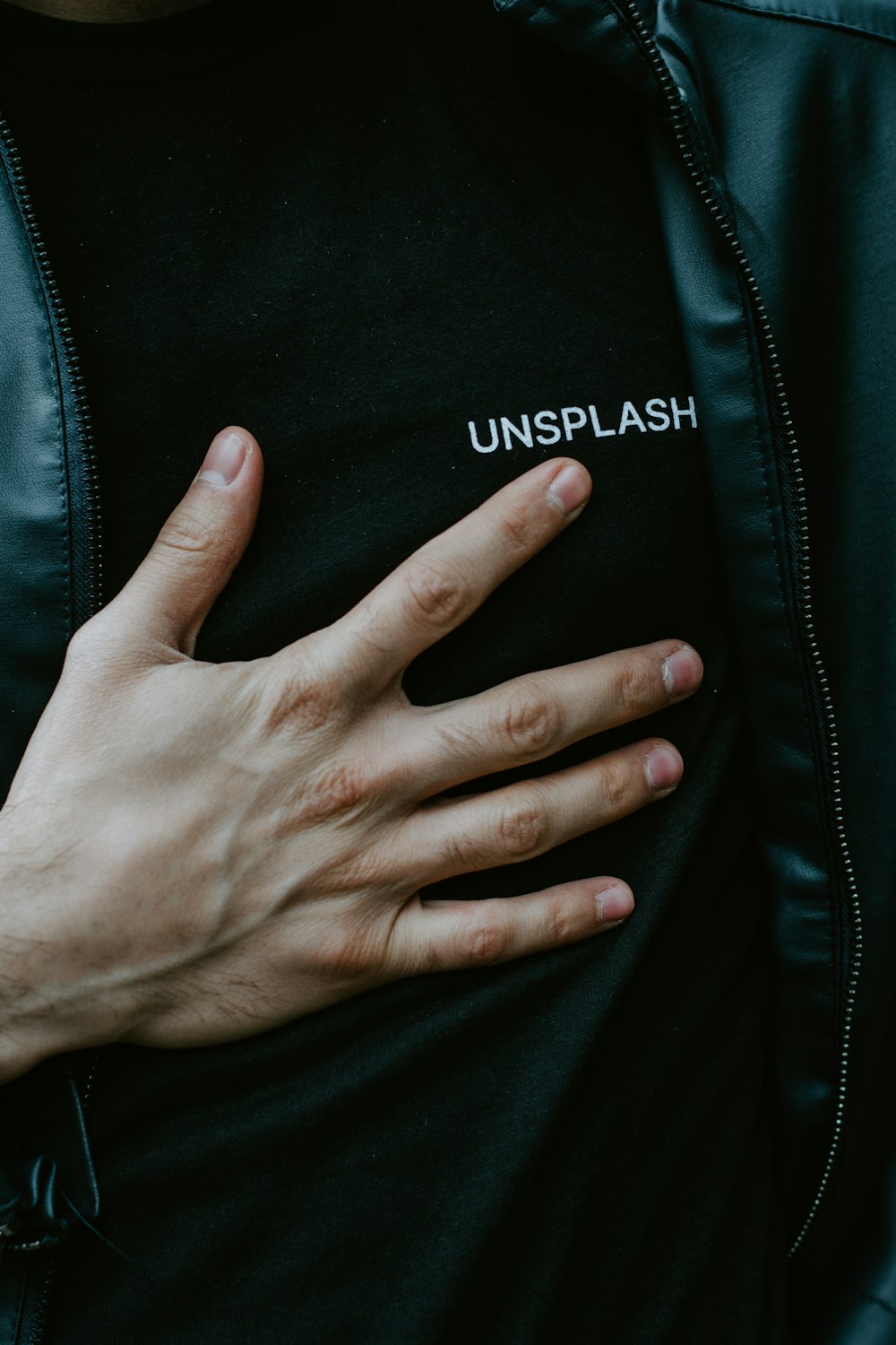 persons left hand on black textile