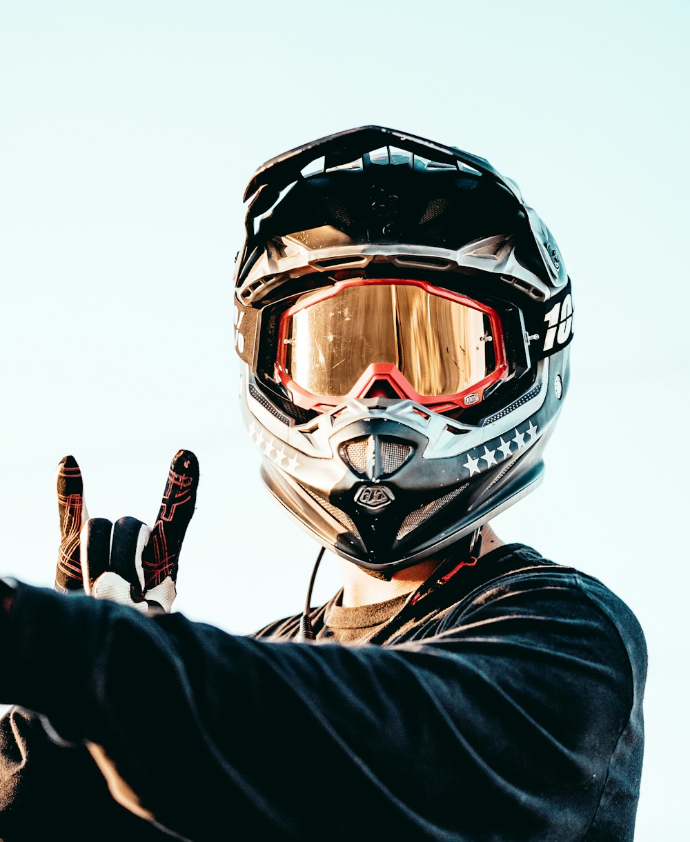 person in black and orange helmet and black jacket