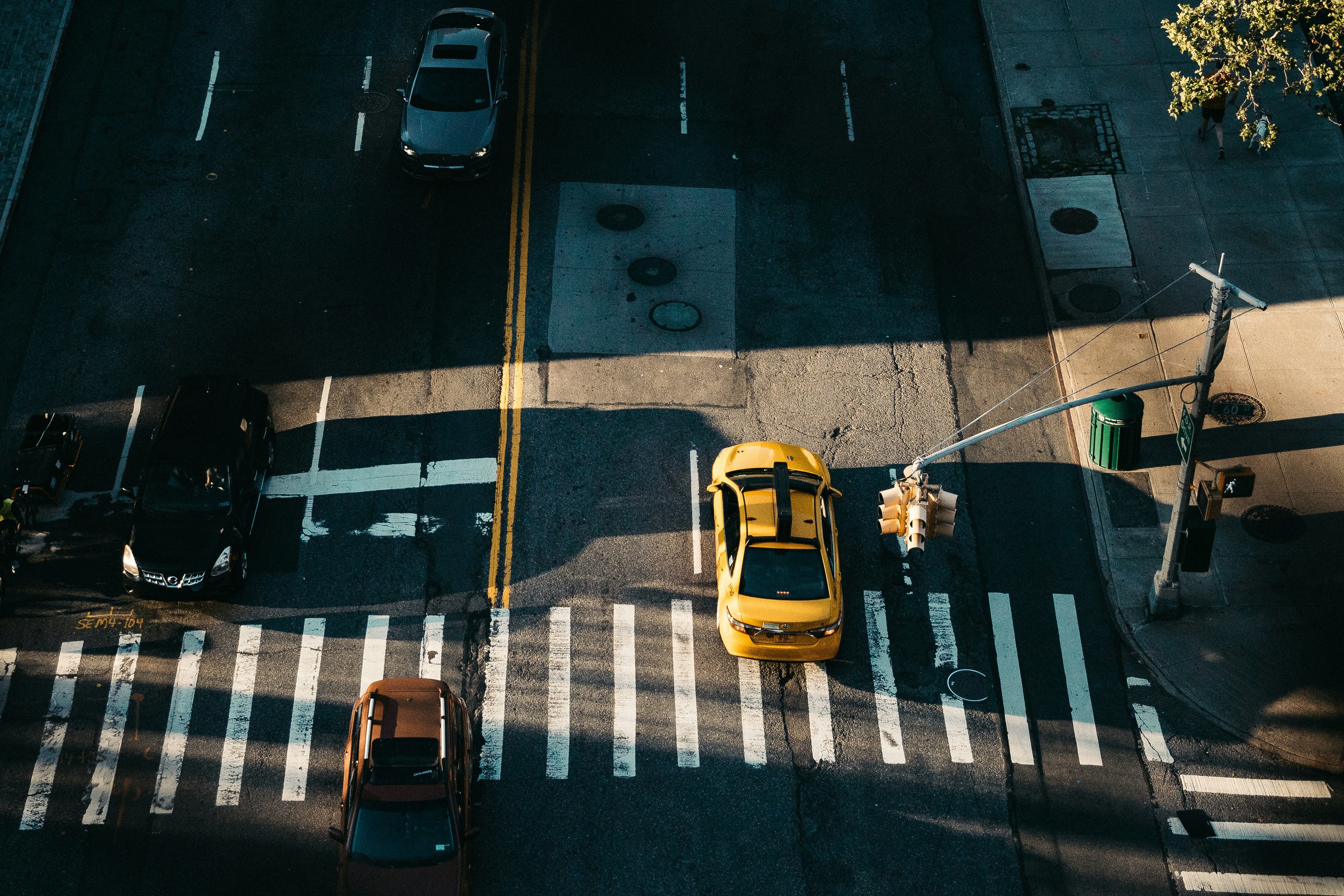 yellow car on pedestrian lane during daytime asphalt teams background