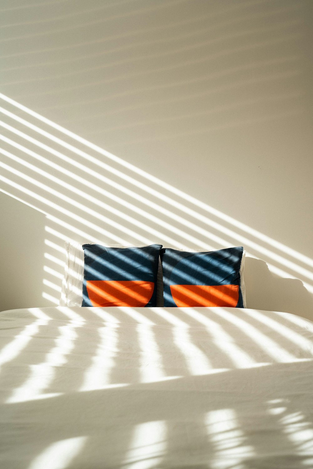 black red and white plaid textile on white bed