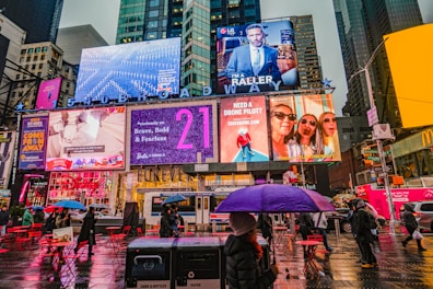 woman in black leather jacket holding pink umbrella