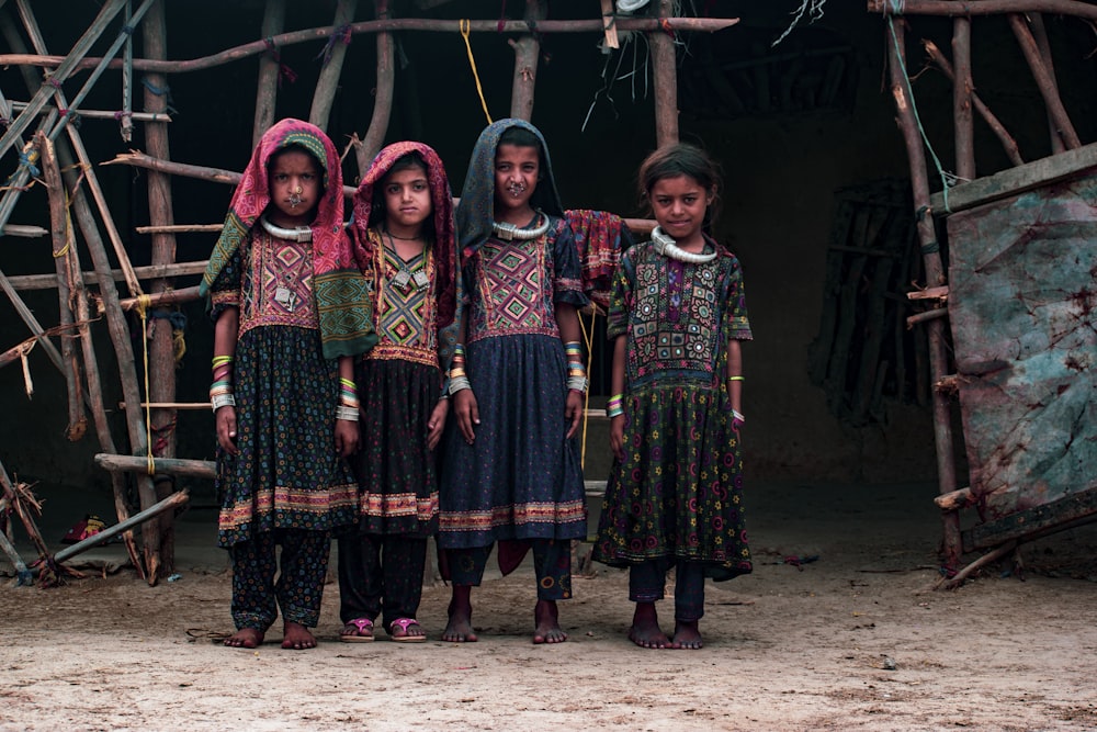 a group of young girls standing next to each other