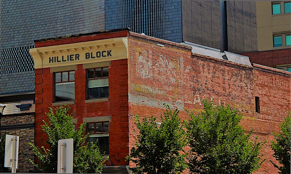 brown brick building with green plants