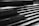 A series of broad, concrete steps are depicted in a high-contrast black and white setting, capturing various angles and shadows. Subtle reflections of light on the damp surfaces create a sleek, modern aesthetic.