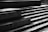A series of broad, concrete steps are depicted in a high-contrast black and white setting, capturing various angles and shadows. Subtle reflections of light on the damp surfaces create a sleek, modern aesthetic.