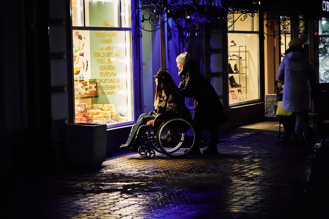 man in black jacket sitting on black motorcycle