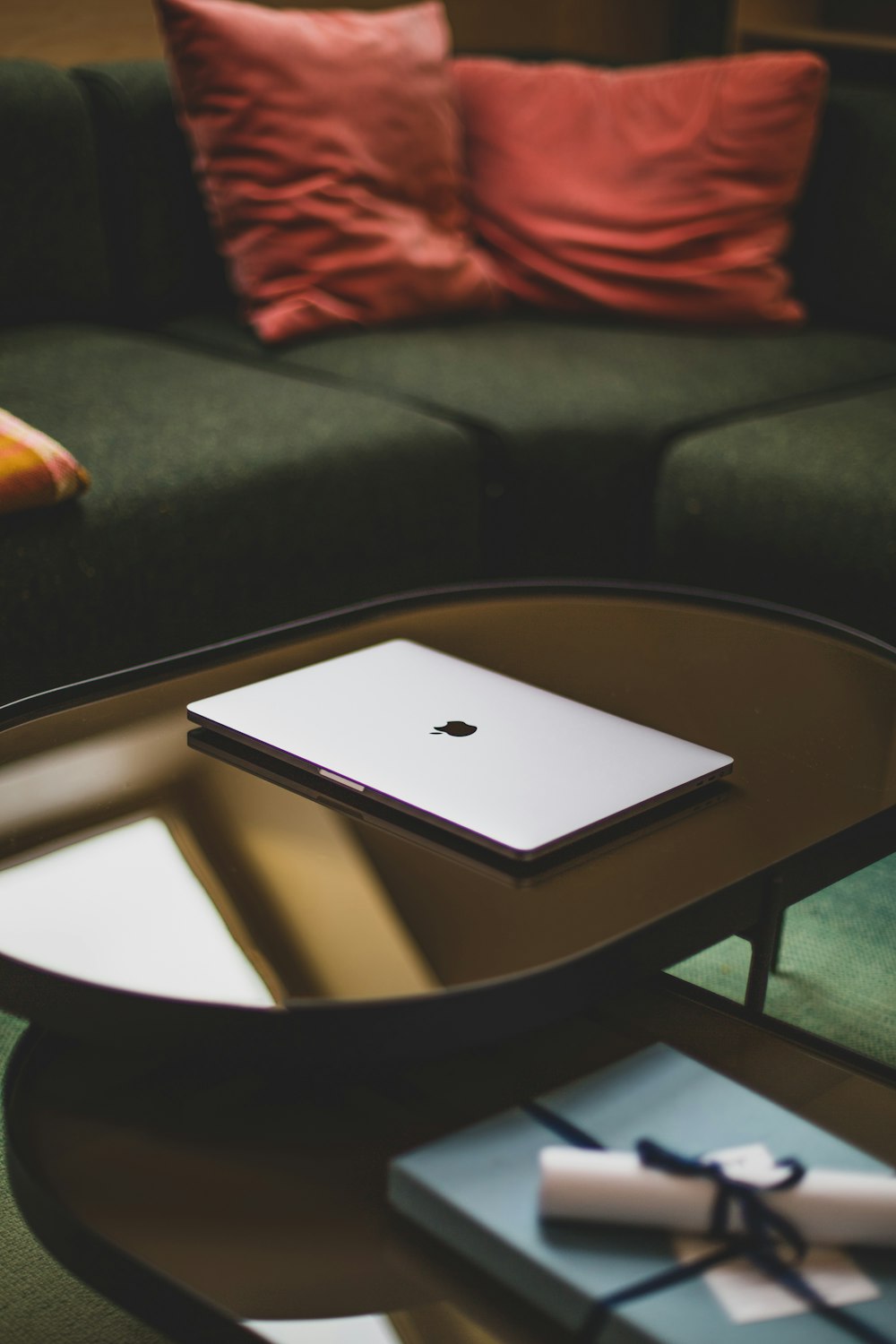 silver macbook on brown wooden table