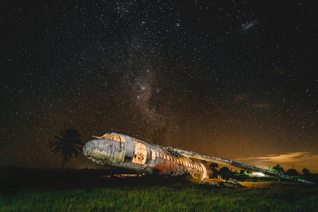 brown and white space ship on green grass field during night time