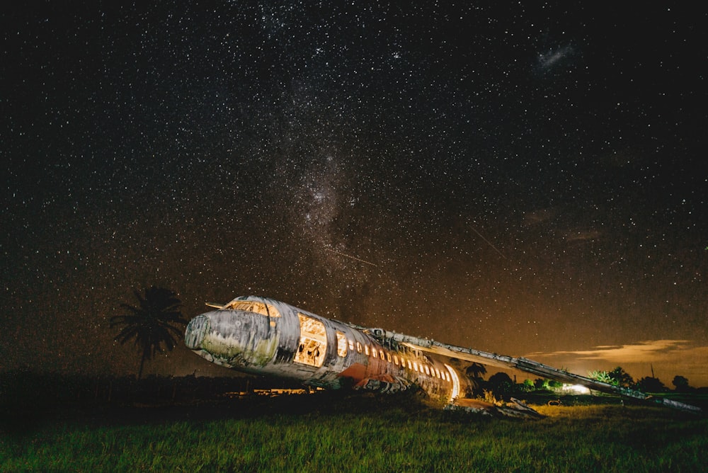 brown and white space ship on green grass field during night time