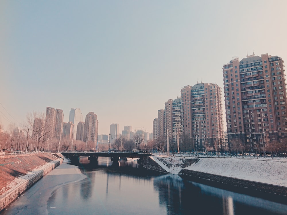 body of water near city buildings during daytime