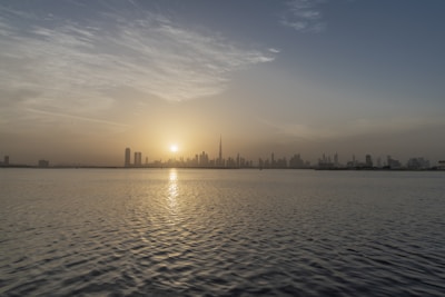 Bright sunrise over a calm city skyline symbolizing new beginnings.