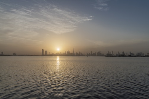 A serene financial landscape with a rising sun over a city skyline.