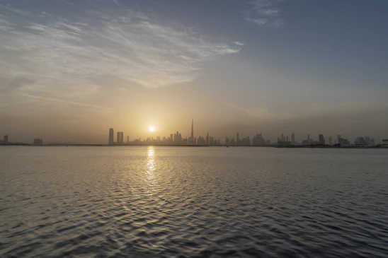 A calm sunrise over a city skyline symbolizing steady and growing investment opportunities.