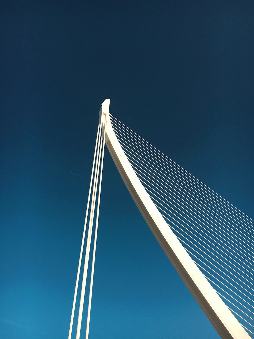 white and black bridge under blue sky