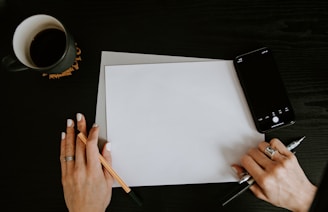 person writing on white paper