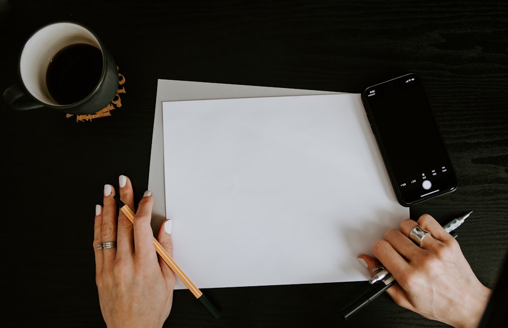 person writing on white paper