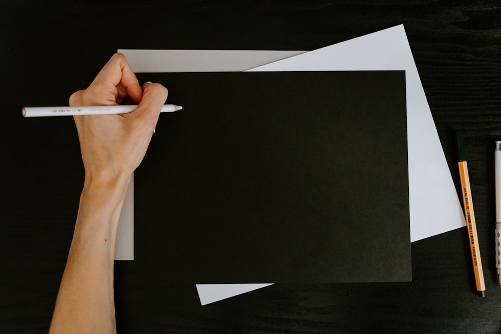 person holding white printer paper