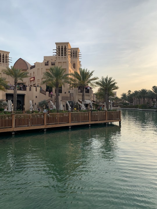 brown wooden dock on lake during daytime in Madinat Jumeirah United Arab Emirates