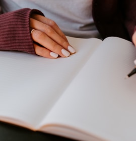 person writing on white paper