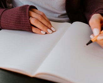 person writing on white paper