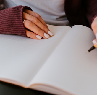 person writing on white paper